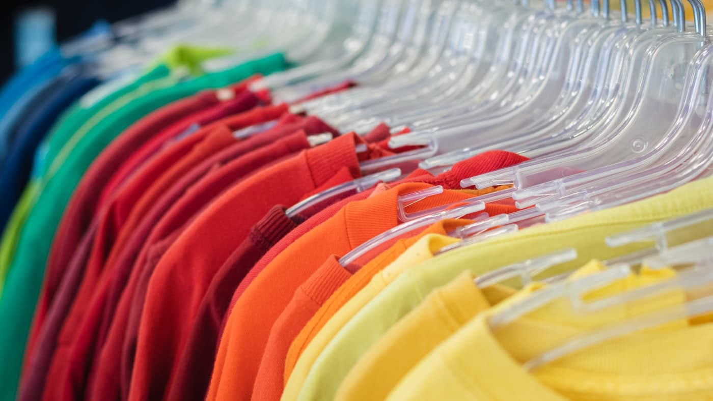 Colourful cotton t-shirts on a rail, representative of the apparel sector