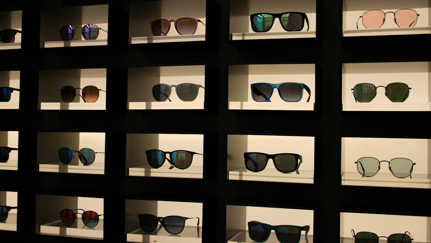 Sunglasses arranged in a lit retail display, representative of the eyewear sector